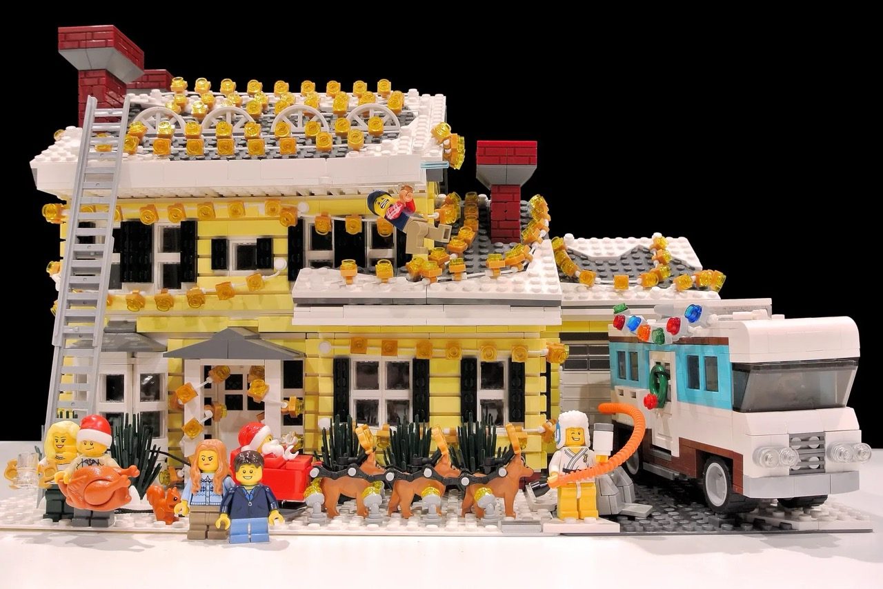 LEGO National Lampoon's Christmas Vacation house set with minifigures, decorated with golden wreaths and holiday details.