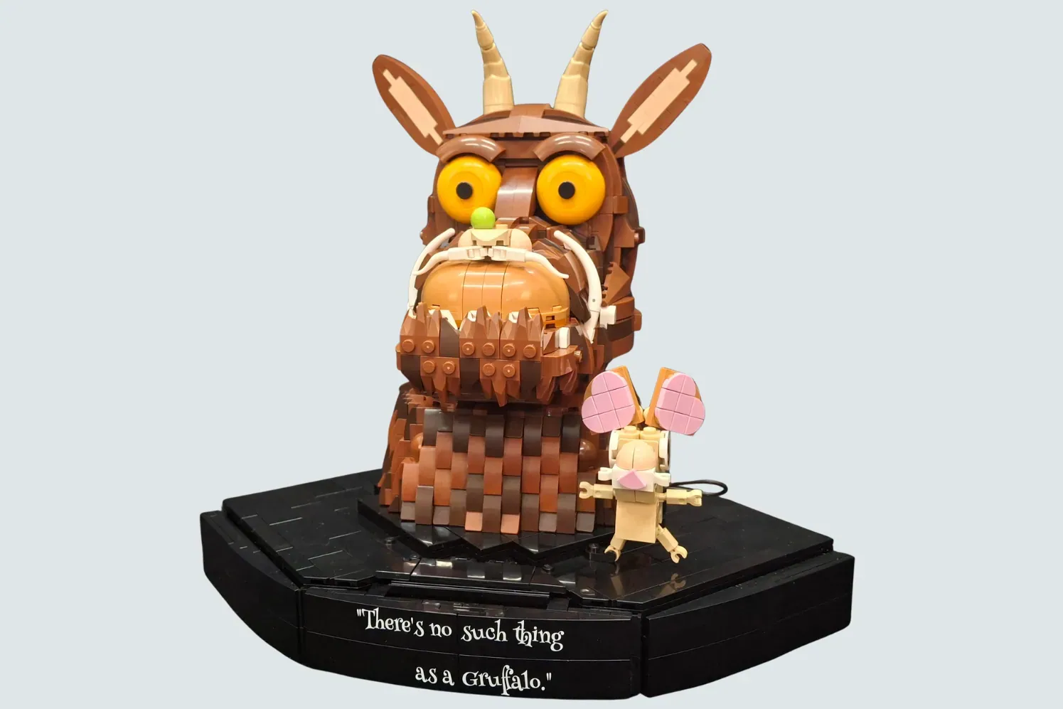 LEGO Gruffalo set with large brown creature figure, small mouse minifigure, and black base with quote.