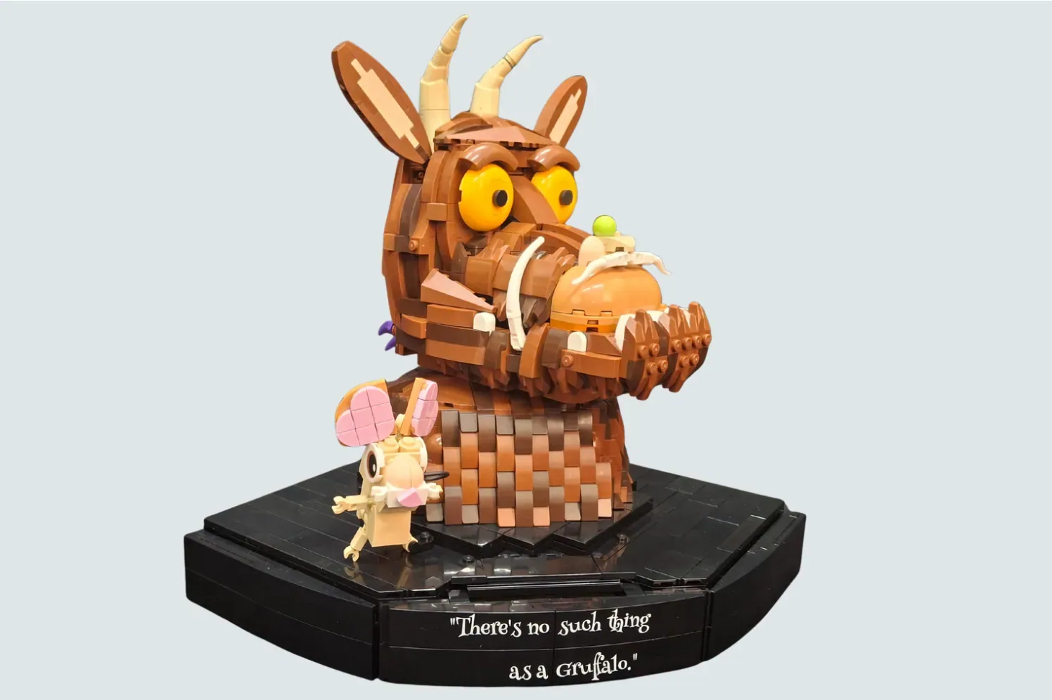 LEGO Gruffalo model with small mouse figure on black base, quote "There's no such thing as a Gruffalo"