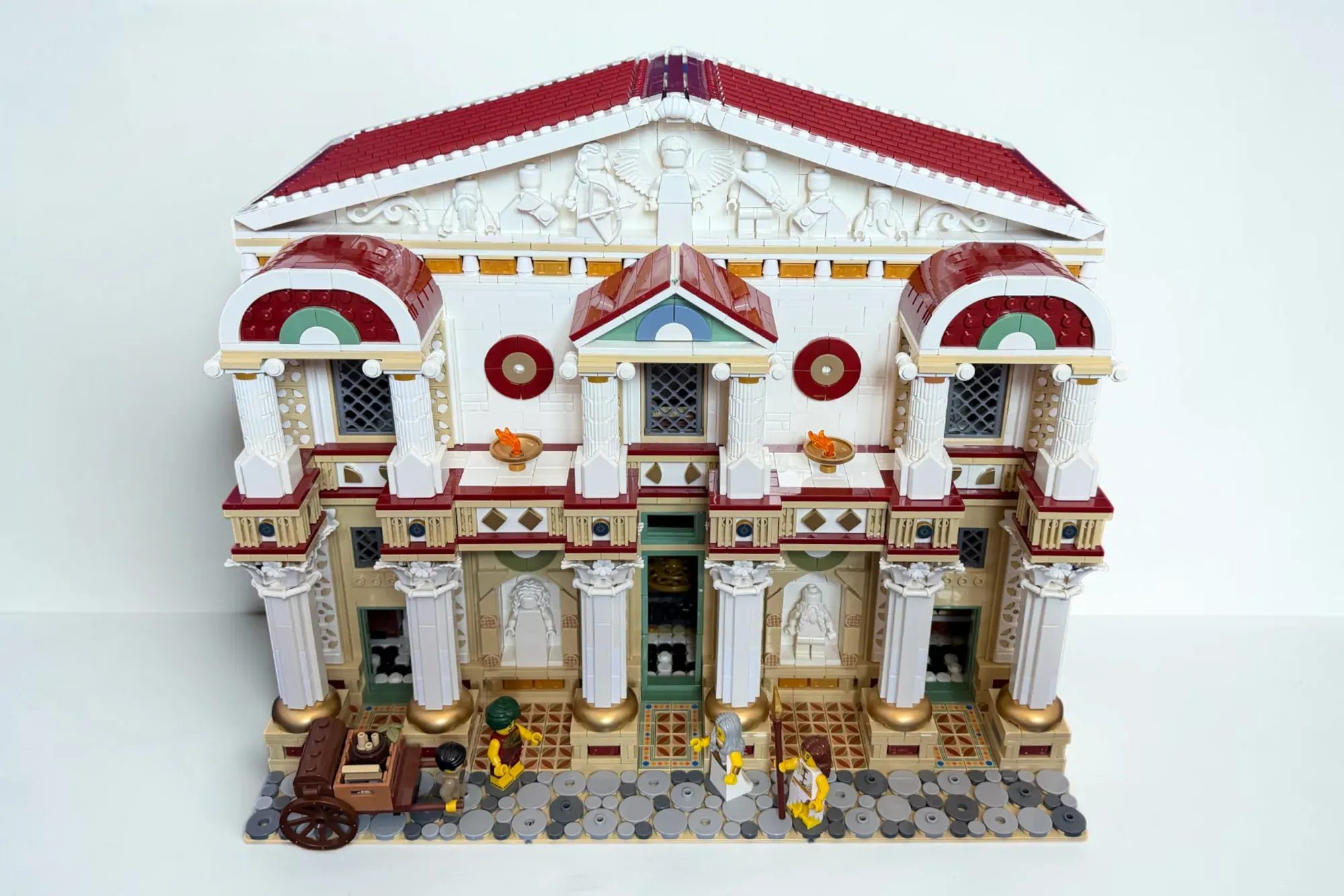 LEGO recreation of the Library of Alexandria featuring red-roofed neoclassical building with white columns and ornate deta…