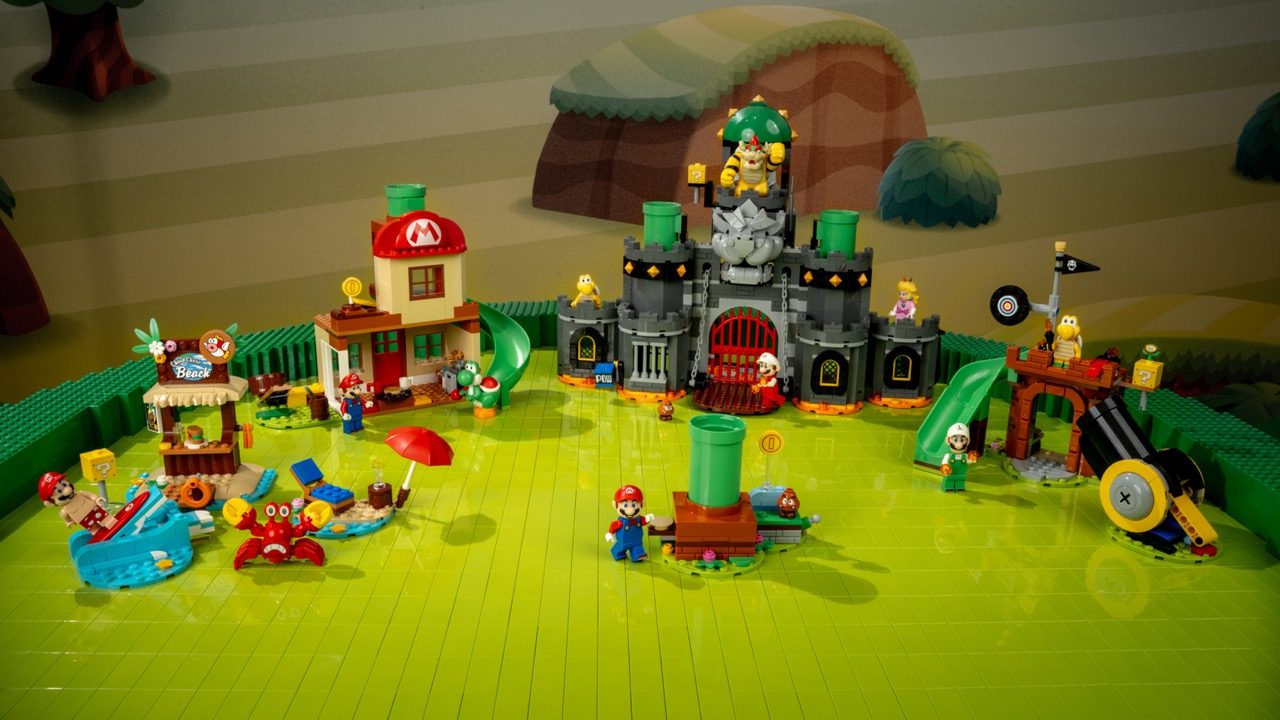 LEGO Super Mario playground set with castle, minifigures, and accessories on green baseplate.