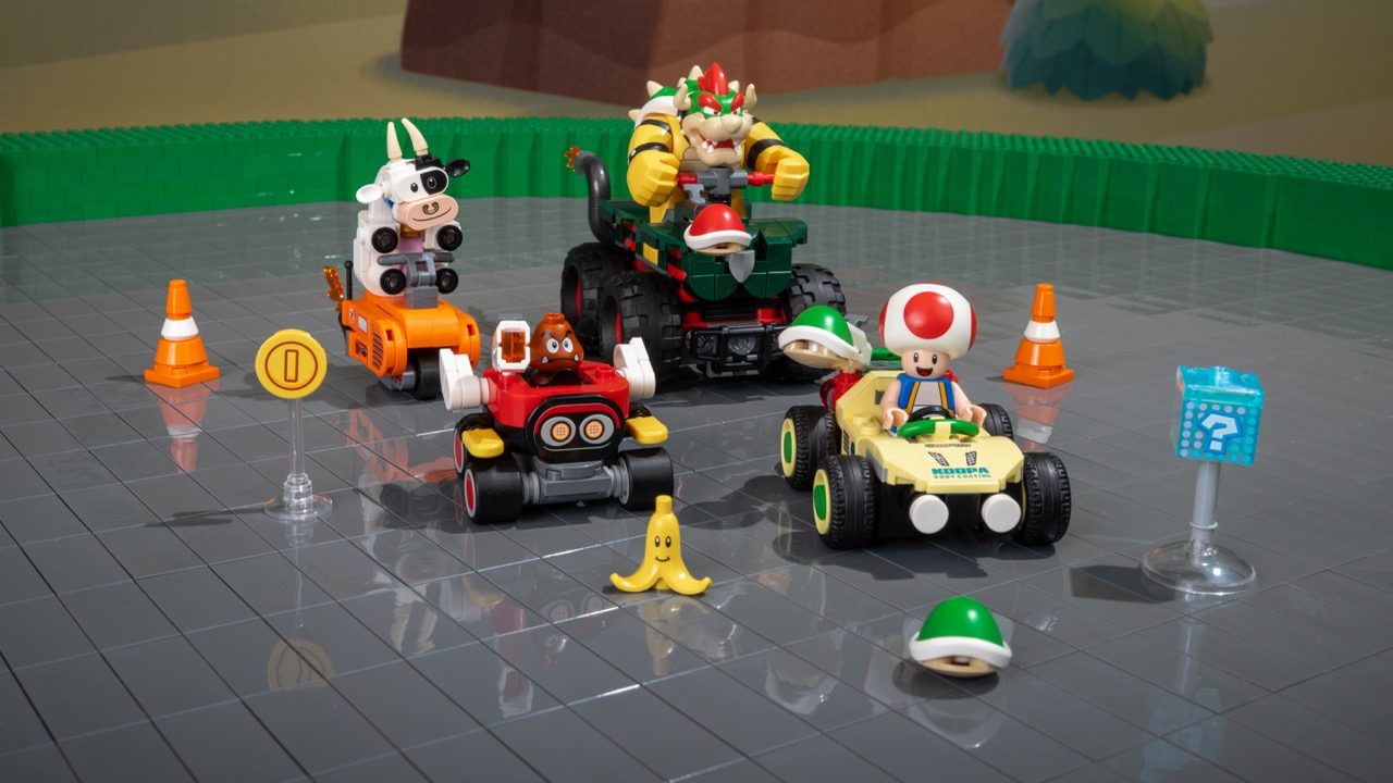 LEGO Super Mario racing set with minifigures, kart vehicles, Bowser, Toad, and track accessories on display.