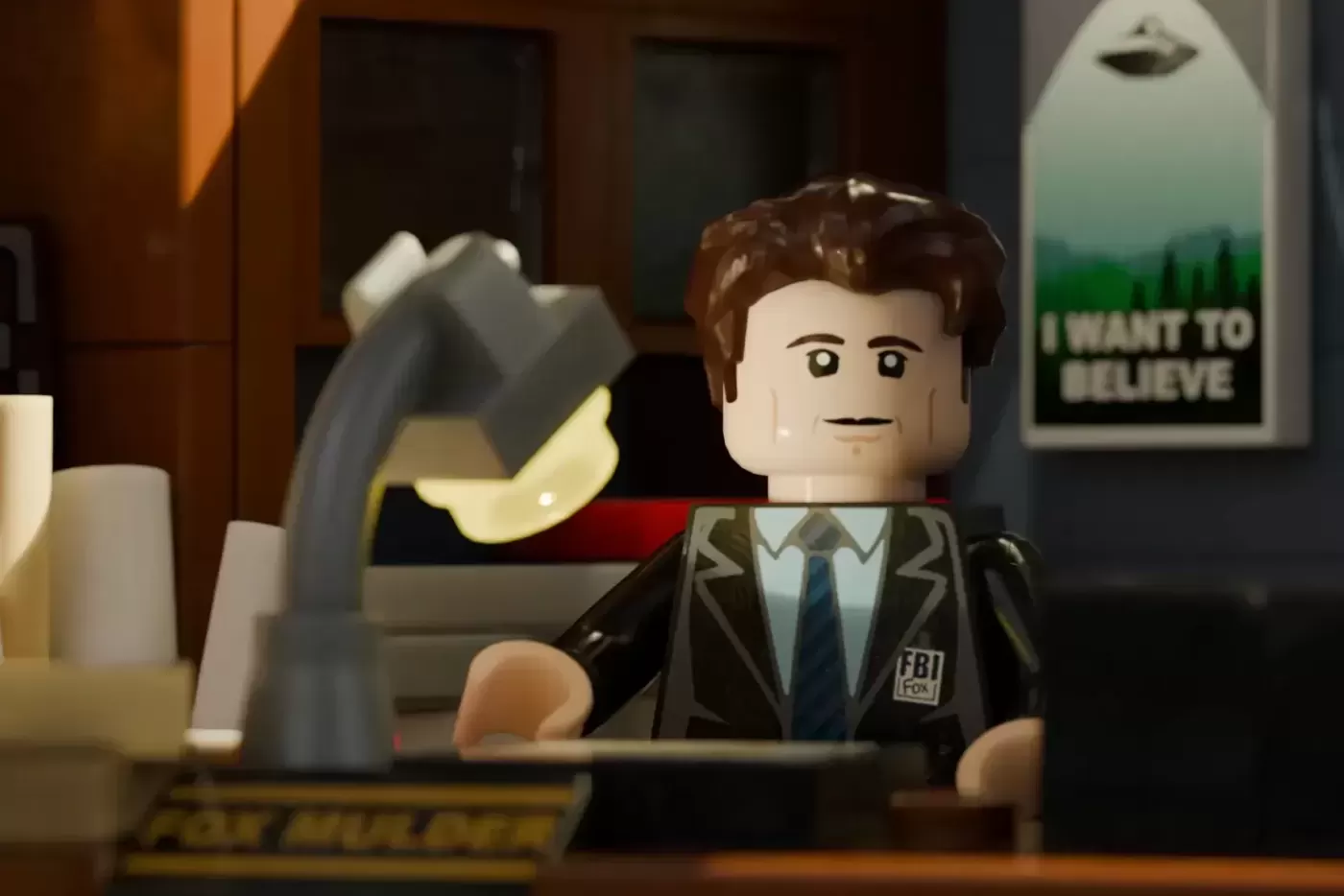 LEGO minifigure of FBI agent in suit at desk in basement office with 