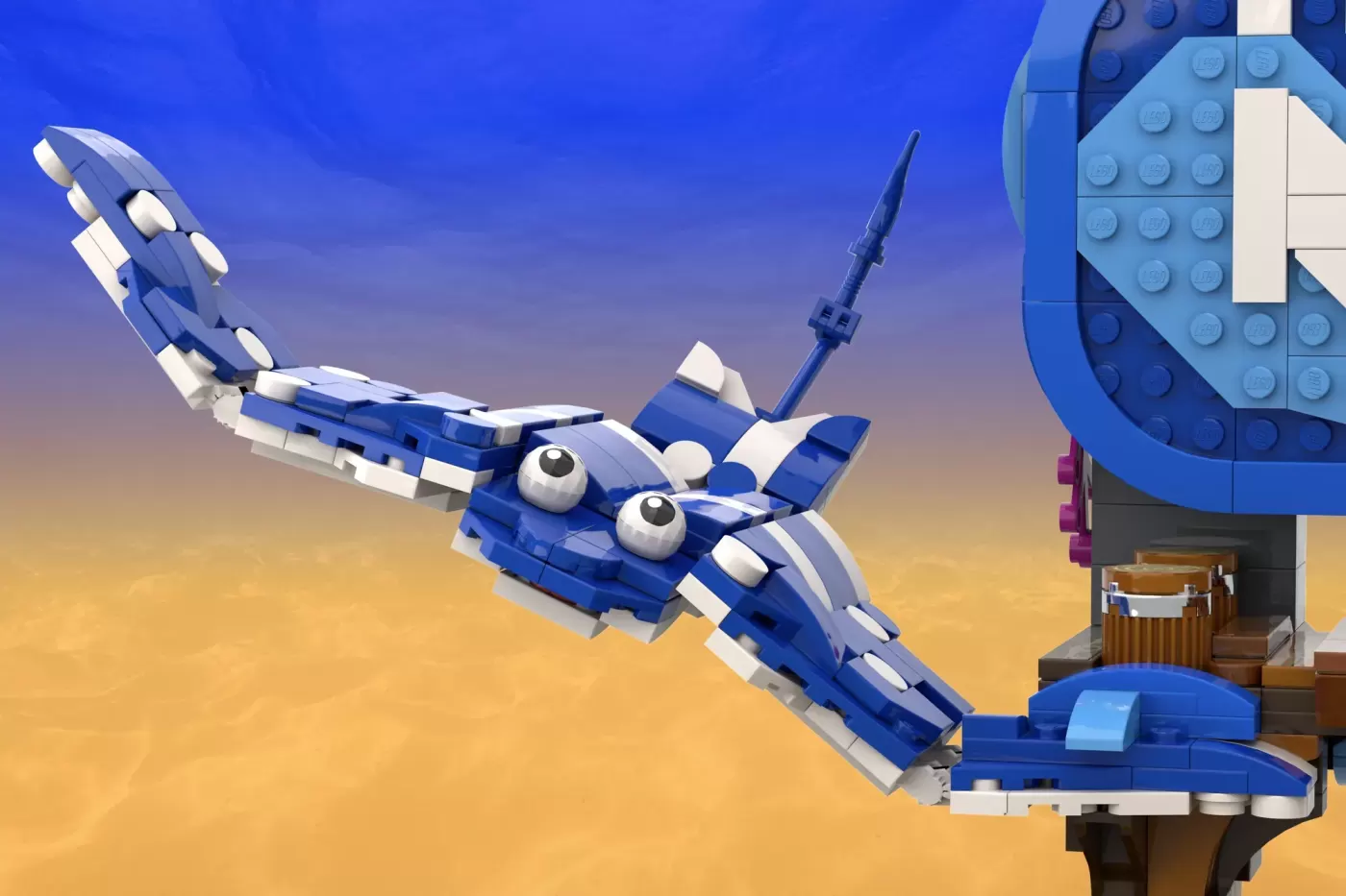 LEGO brick model of a blue and white fish with large eyes next to a seaside structure against a gradient sky.