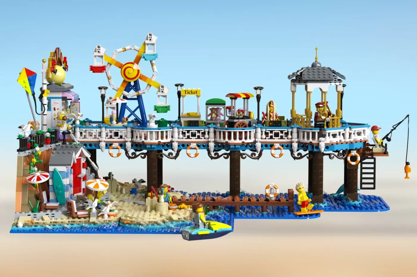 Elaborate LEGO Victorian pier set with amusement rides, ticket booth, pavilion, beach structures, minifigures, and jet ski.