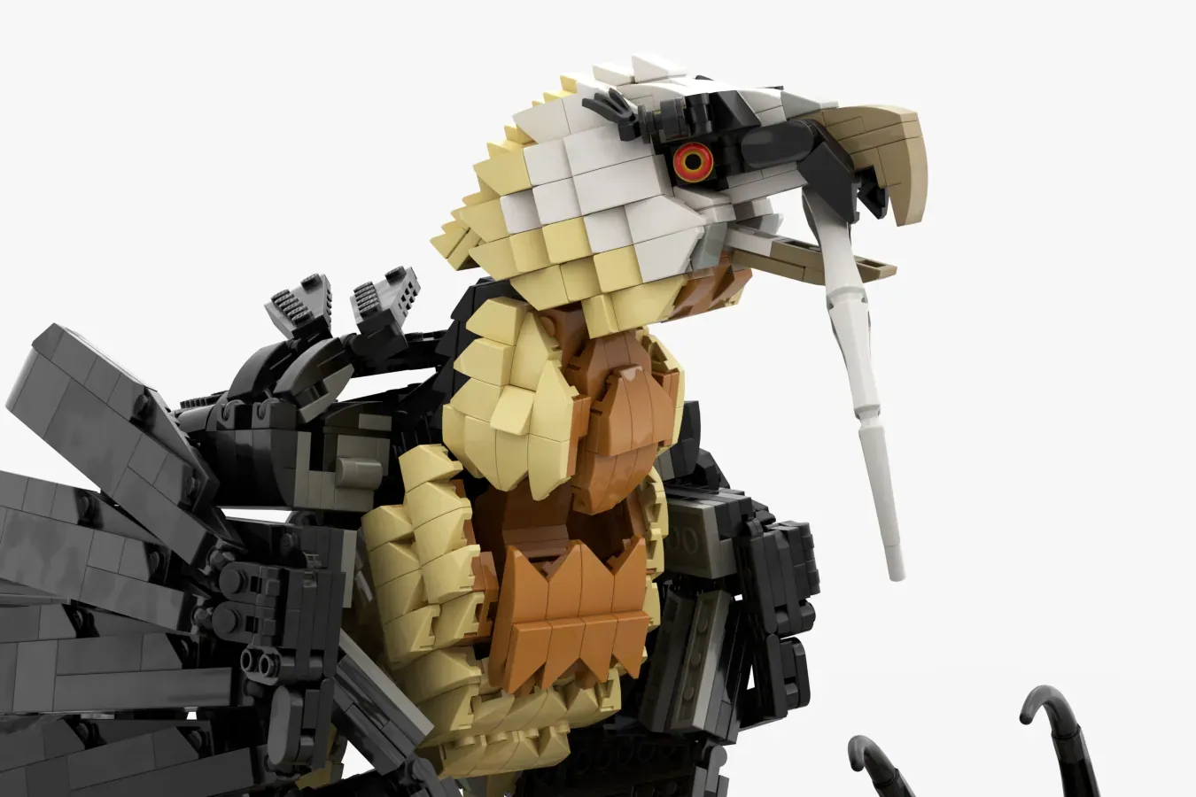 LEGO bearded vulture with tan and cream plumage, black wings, articulated joints, and orange eye detail.