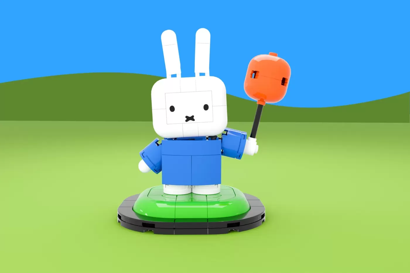 LEGO Miffy figure in blue outfit holding orange lollipop on green base against grassy landscape backdrop.