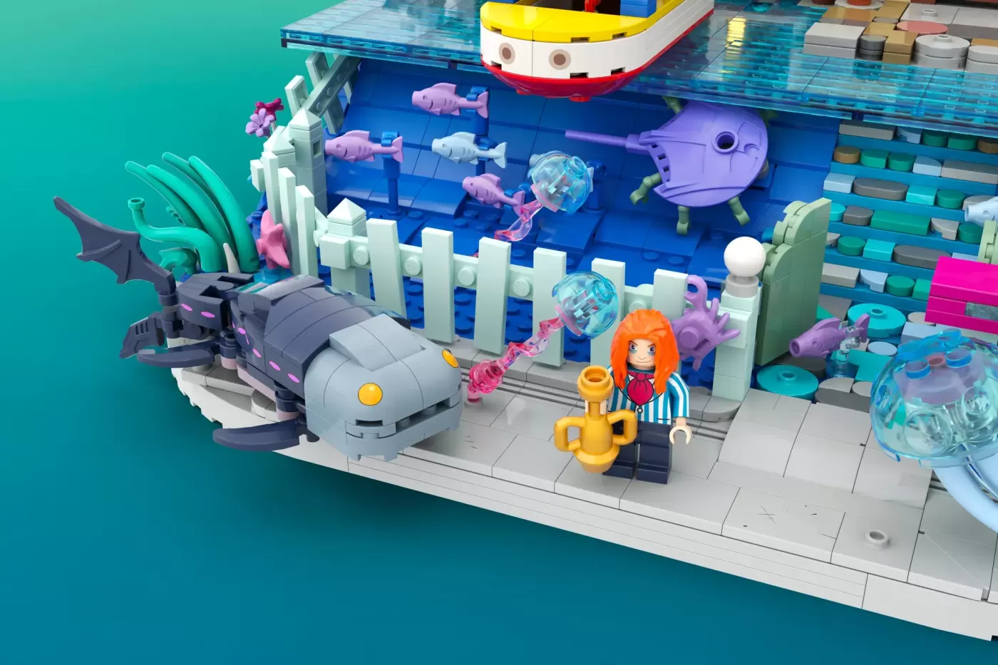 LEGO Ponyo underwater set featuring minifigure with orange hair, goldfish, submarine vessel, and colorful sea creatures.