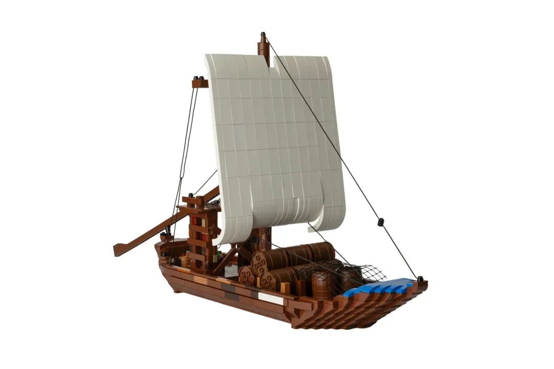 LEGO Barco Rabelo model featuring brown wooden hull, white sail, cargo barrels, and rigging details.