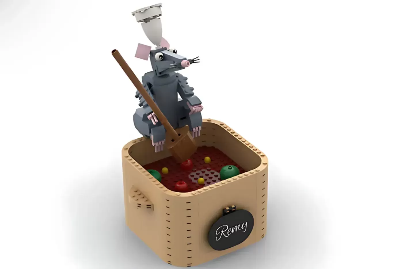 LEGO Remy rat figure with chef's hat standing in wooden pot with red liquid and colorful balls inside, labeled "Remy."