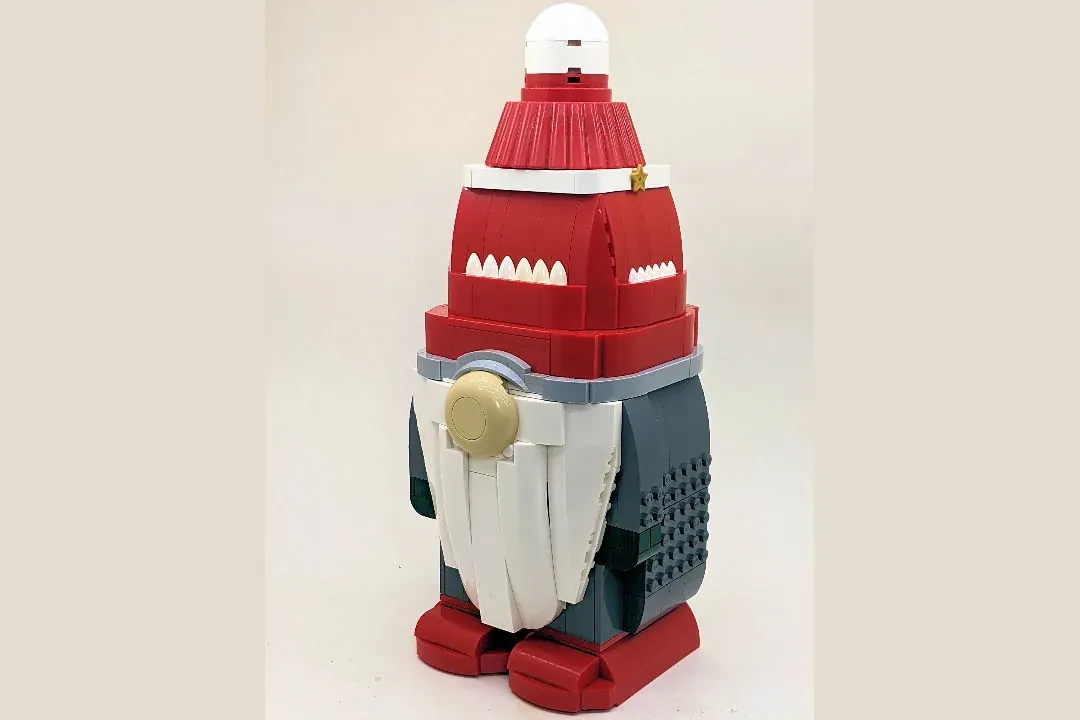 LEGO Christmas Gnome figure with red and white hat, red body, white beard, and dark legs with textured details.