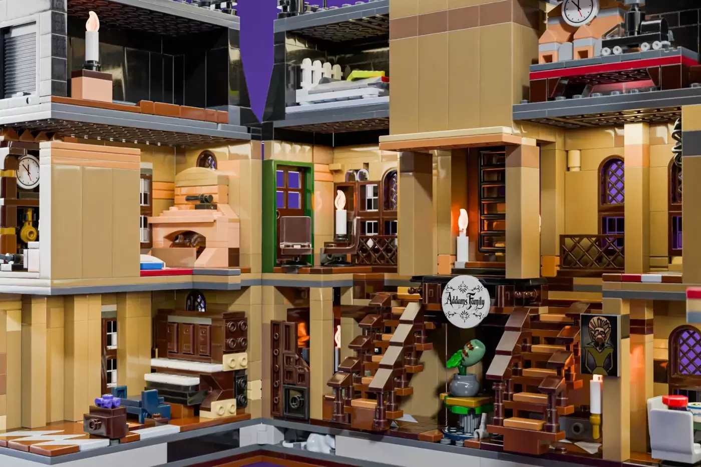 LEGO Addams Family Mansion with detailed interior rooms, dark wood furnishings, yellow walls, and spooky decorations throu…