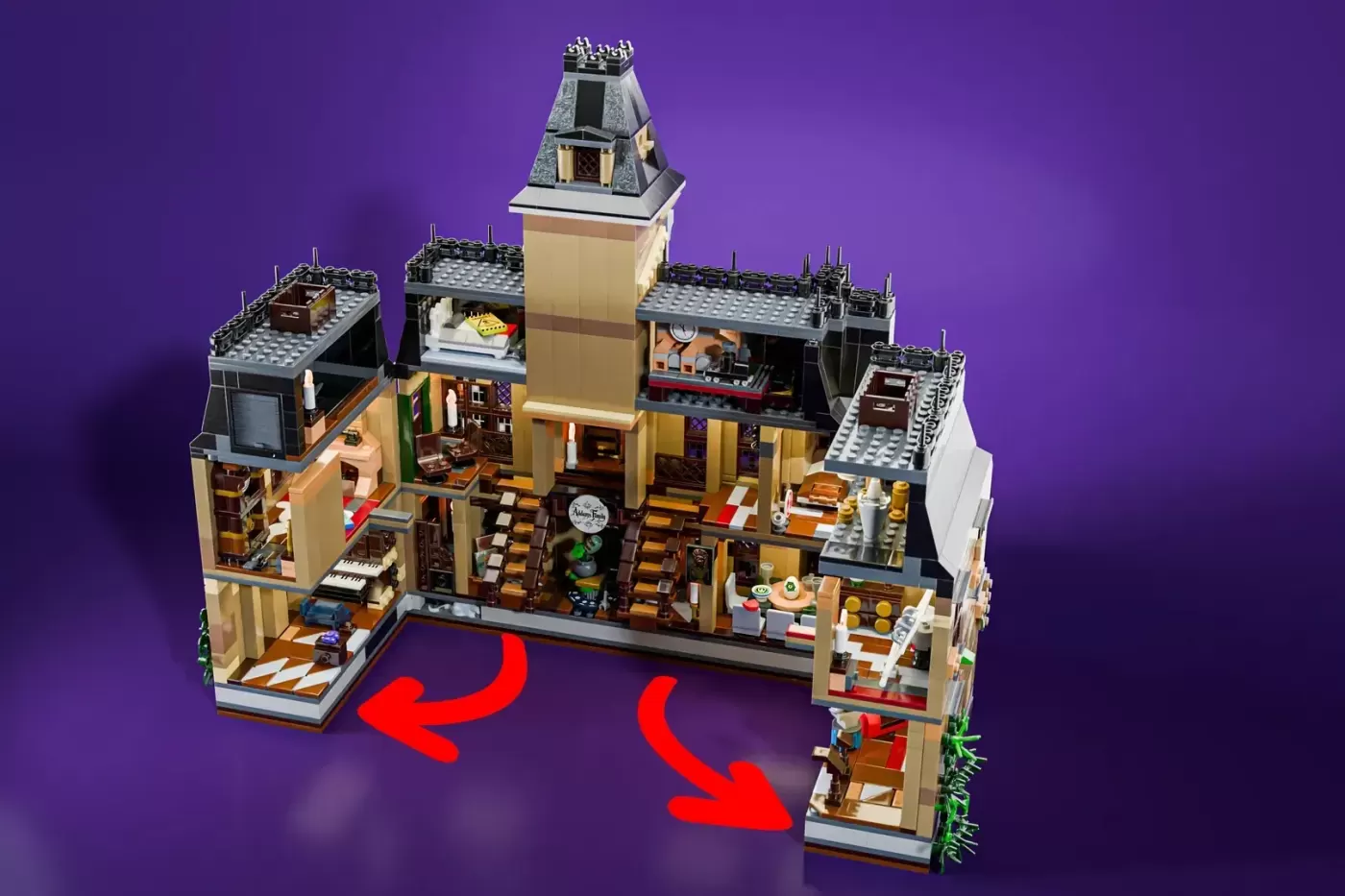 LEGO Addams Family Mansion with tower, multiple rooms, and red arrows indicating expandable sections on purple background.