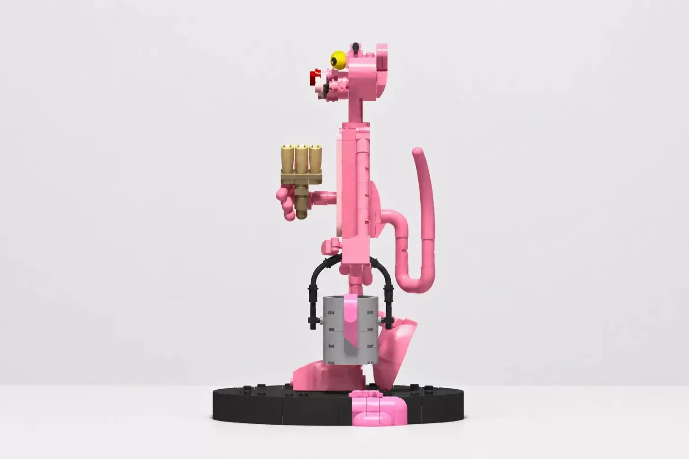 LEGO Pink Panther figure holding a paintbrush, standing on black base with articulated limbs and detailed features.