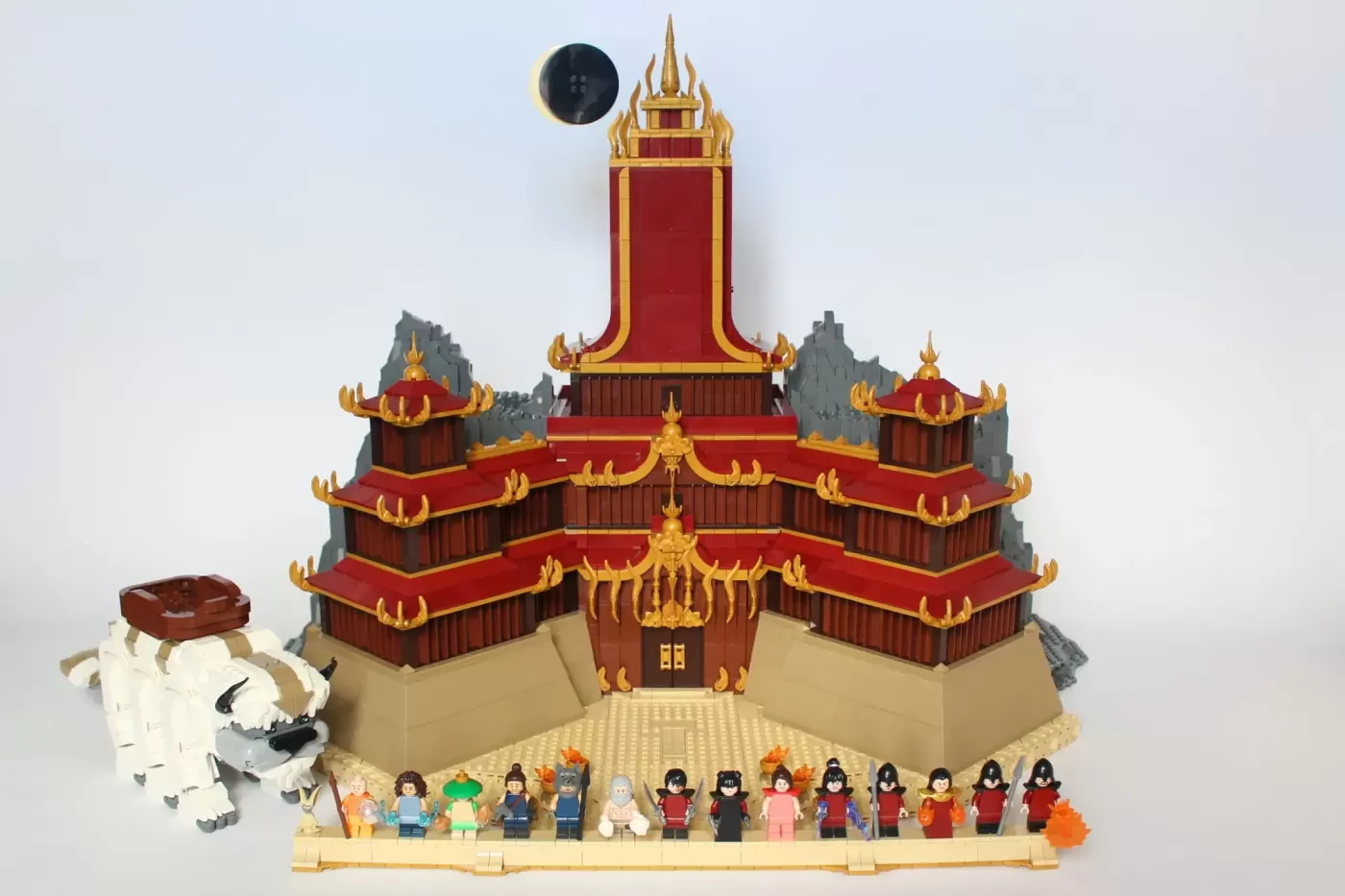 LEGO Fire Nation Palace with Appa figure, 15 minifigures, and detailed architecture featuring red roofs and golden spires.