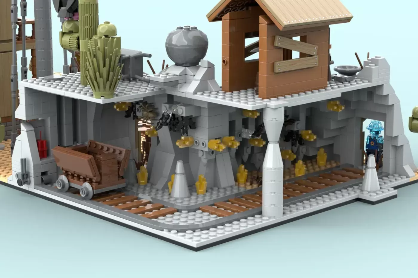 LEGO Old Western town set featuring gray buildings, wooden structures, cacti, mining cart, and minifigures on baseplate.