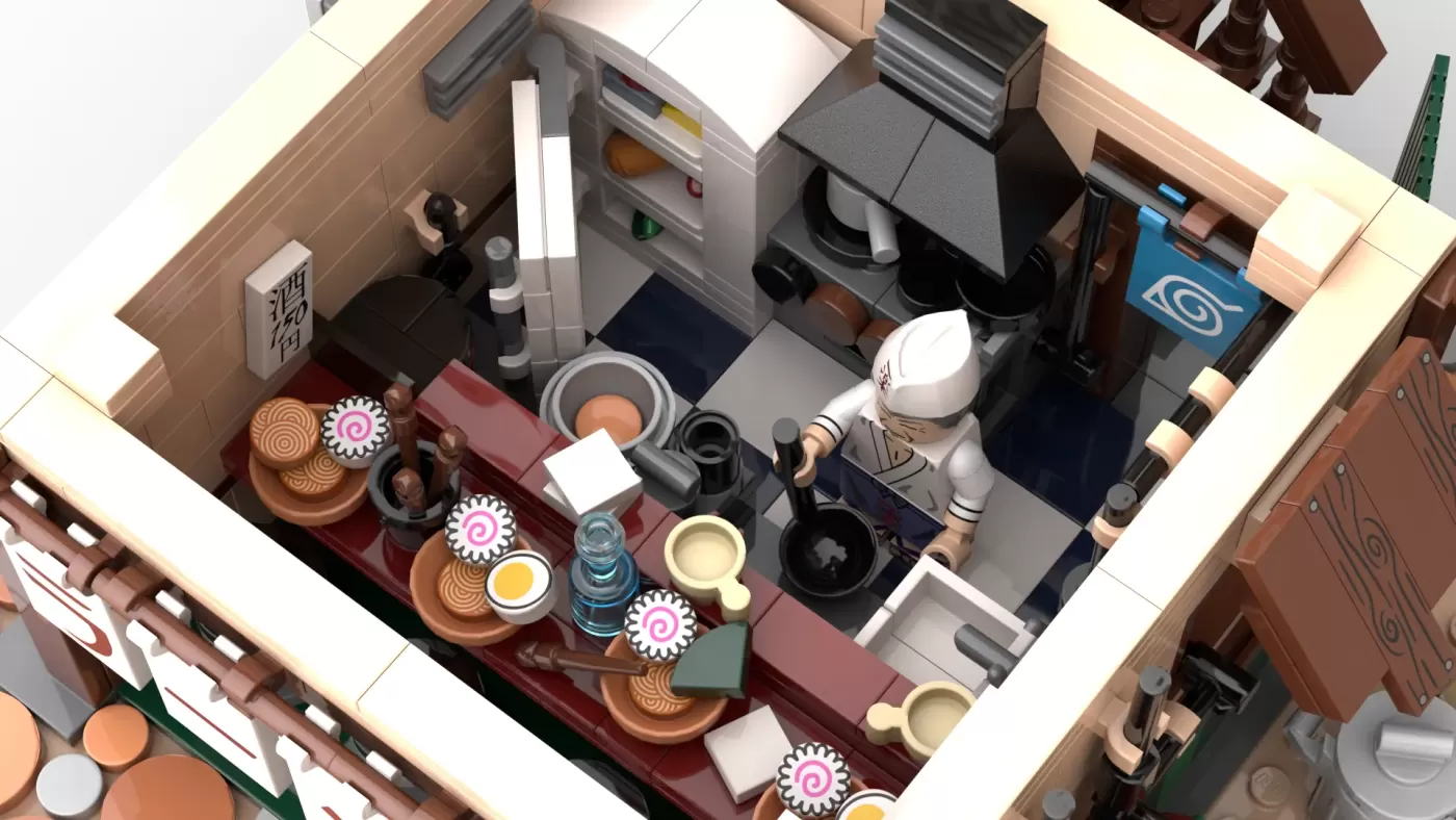 Overhead view of LEGO Ichiraku Ramen Shop with minifigure, counter, kitchen appliances, and detailed ramen bowls.