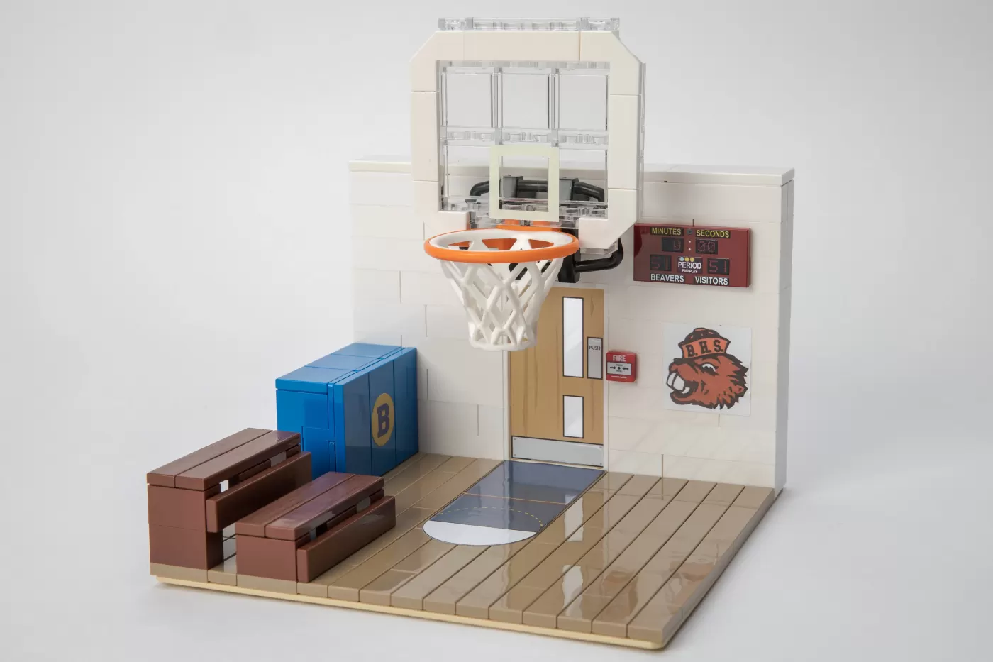 LEGO gym set with basketball hoop, scoreboard, bleachers, and BHS wolf mascot logo.