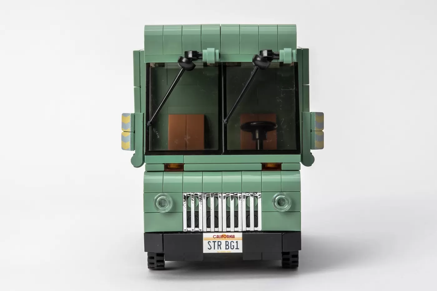 Mint green LEGO brick-built Wolfmobile with dual windshields, black wipers, brown interior details, and California license…