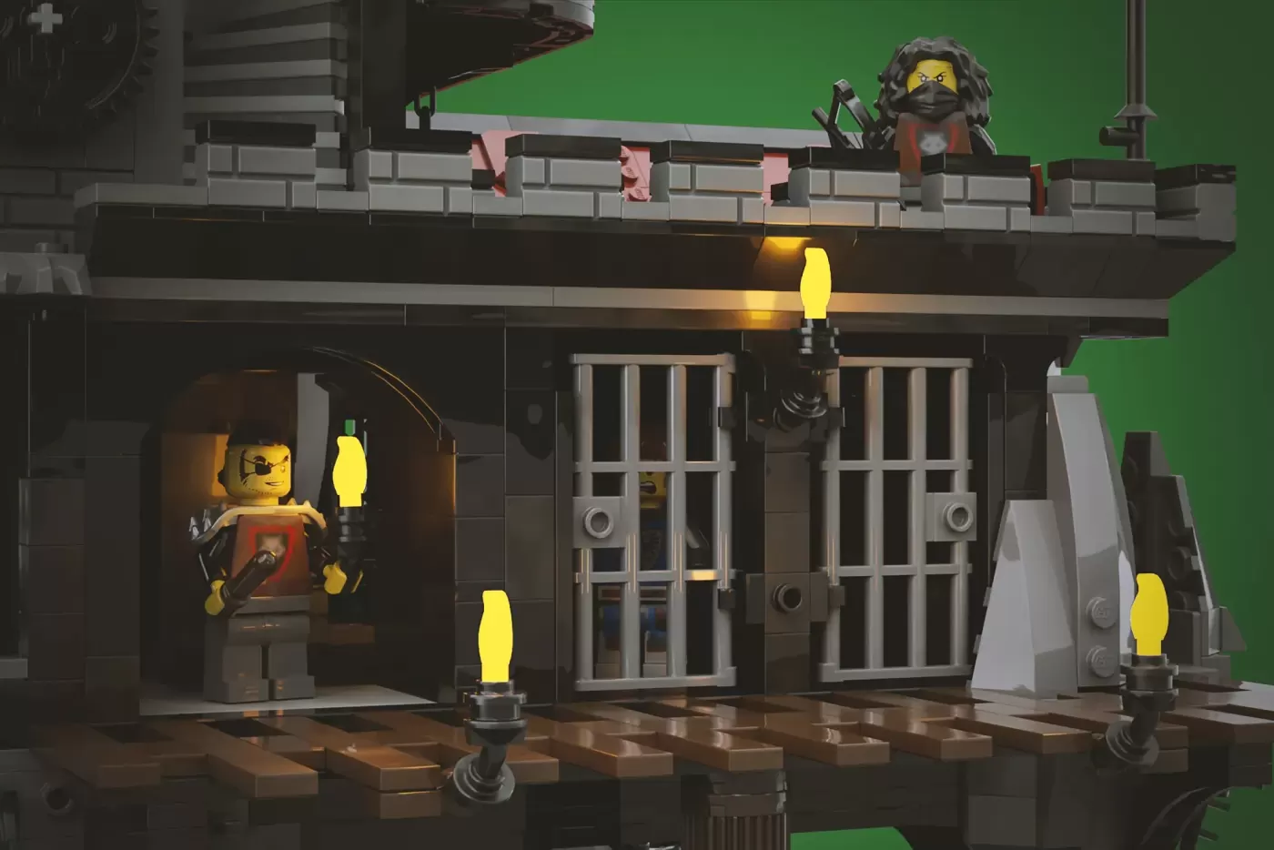 LEGO castle dungeon with barred cells, torches, and minifigures in medieval guard attire on green screen backdrop.