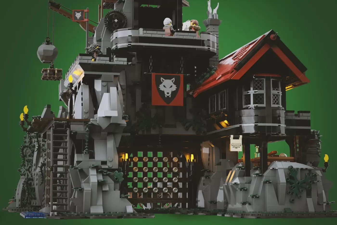 Detailed LEGO castle set featuring a giant stone wolf head, tower, red-roofed house, chess board, and multiple minifigures…