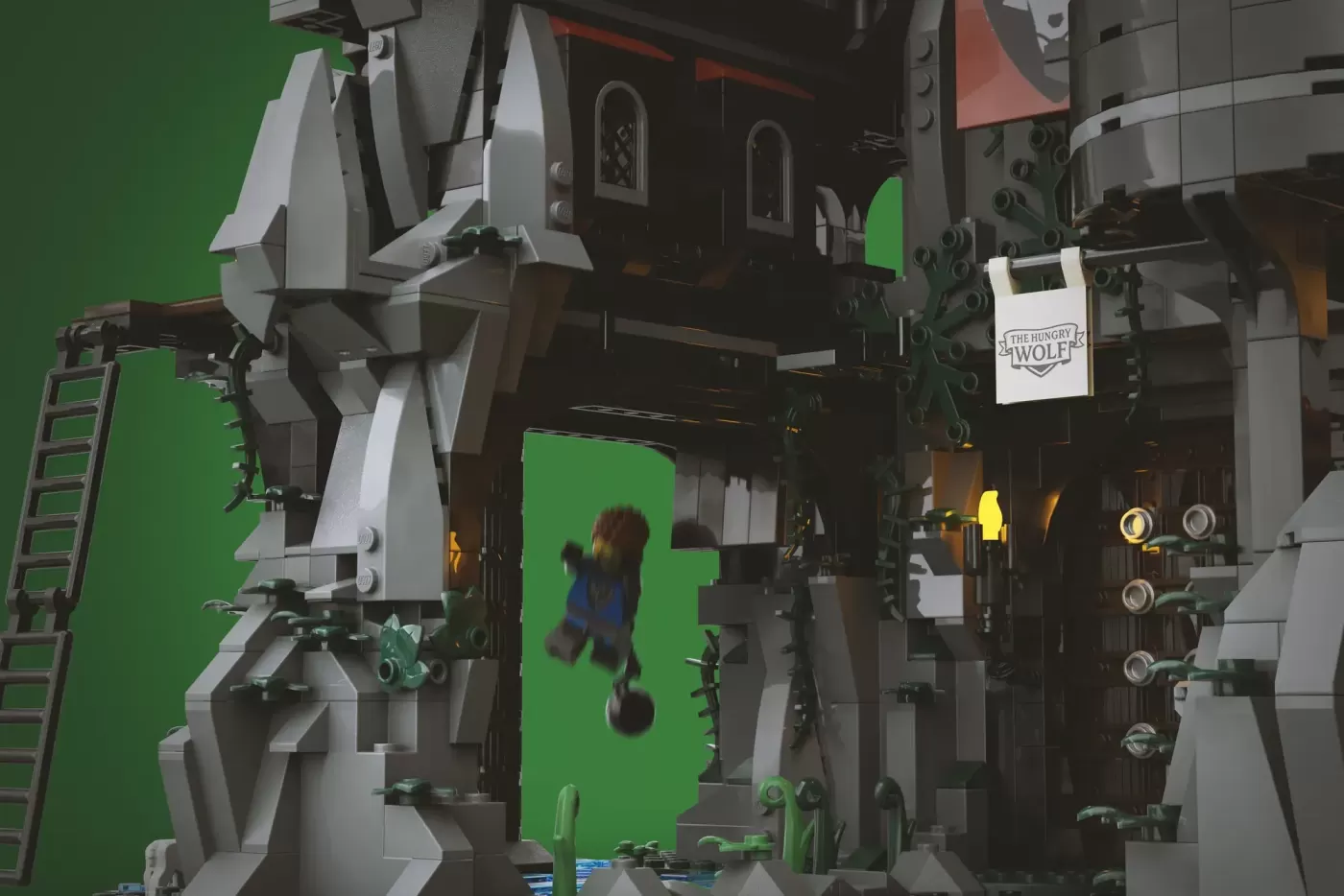 LEGO castle set with minifigure against green screen, featuring stone wolf architecture and detailed medieval structures.